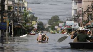 A Thai resident braves chest-deep floods in Bangkok, Thailand.