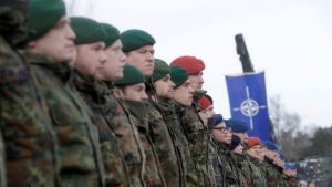 Soldiers wearing berets stand in a line
