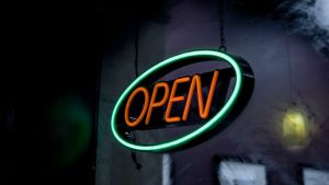 An illuminated OPEN sign outside of a business