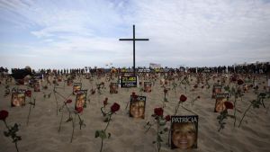 Flowers and pictures of victims of street violence are placed on Copacabana beach in Rio de Janeiro.