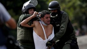 A demonstrator is detained at a rally during a strike called to protest  Venezuelan President Nicolas Maduro's government