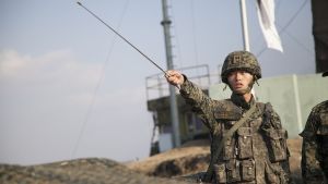 Republic of Korea Army 1st Lt. Choi Min Kyu points across the border into North Korea while briefing Vice President of the United States Joe Biden, at Observation Point Ouellette, South Korea, Dec. 7, 2013. 