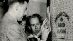Clifton Utley puts lettering on a glass on a door