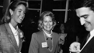 Black and white photo of three members talking and laughing