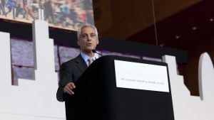 Rahm Emmanuel speaking behind a podium on-stage
