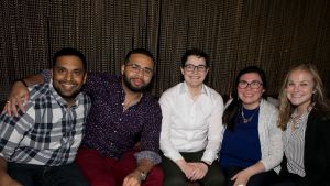 Five people sit at a table at the YP Pub Quiz