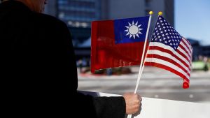 A demonstrator holds US and Taiwan flags