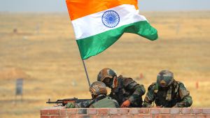 Indian flag and three soldiers on a parapet.