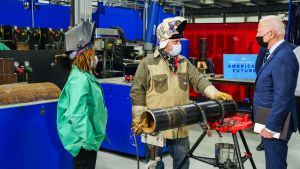Biden observes trainers and apprentices at work at the welding station during a tour of Plumbers & Gasfitters Local 5 Training Facility