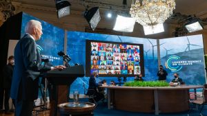 Biden in front of a screen at a climate summit.
