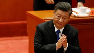 Xi Jinping clapping his hands while speaking