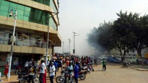 Smoke billowing from a street in Kampala after an explosion.