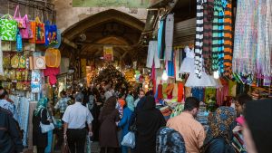 A crowd of people at the entrance to a market in Tehran