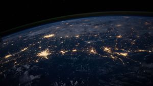 Wide shot of earth's cities at night from space.