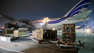 Workers unload a shipment of military aid to Ukraine from the United States.