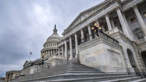The United States capitol building with dark clouds above wide angle shot in Washington, DC.