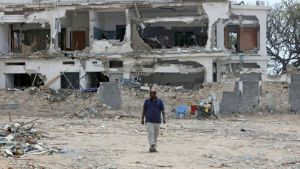A man walks at the site of the Oct 14 bombings in Mogadishu, Somalia.