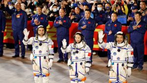 Astronauts Ye Guangfu, Zhai Zhigang and Wang Yaping wave during a ceremony ahead of the launch of the Long March-2F Y13 rocket