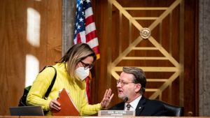 Senator Kyrsten Sinema, a Democrat from Arizona, speaks with Senator Gary Peters, a Democrat from Michigan 