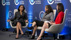 three women having a discussion on stage during the symposium