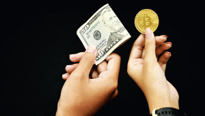 two people exchange money and bitcoin