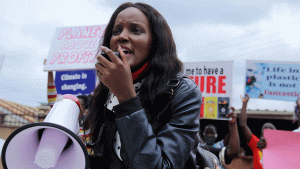 Vanessa Nakate speaks into megaphone during a demonstration for climate change.