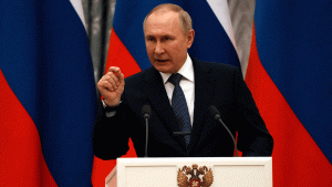 Putin points at a podium