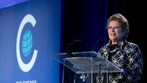 A woman speaking into a microphone behind a podium