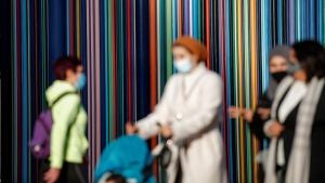 Women wearing protective face masks walk at the financial and business district of La Defense, amid the outbreak of the coronavirus disease (COVID-19), in Paris, France, November 9, 2020.