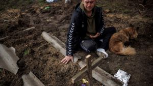 Man mourning over grave.