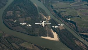 A Romanian Air Force C-27 Spartan transport aircraft flies in formation together with two Italian Air Force Eurofighter Typhoons (right), two UK Royal Air Force Eurofighter Typhoons (left) and two Romanian Air Force F-16 Fighting Falcons (both sides) above Otopeni, Romania