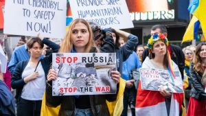 Protesters hold signs against Putin in NYC.