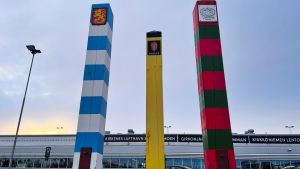 The border posts of Finland (blue and white), Norway (black and yellow) and Russia (red and green), stand outside the airport of the Norwegian Arctic town of Kirkenes