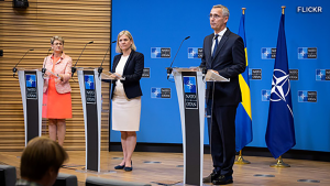 NATO Spokesperson, Oana Lungescu, Swedish PM Magdalena Andersson, and NATO Secretary General Jens Stoltenberg speak at a NATO conference.