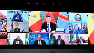 world leaders appear on screen at the Forum on China-Africa Cooperation