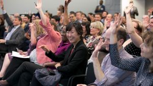 Audience at a Council event raising their hands
