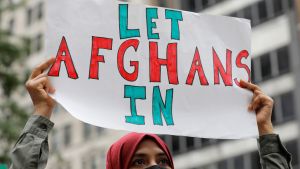 A demonstrator holds up a sign that says Let Afghans In during a rally in New York City 