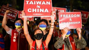Protestors hold up red signs saying Taiwan does not equal China.