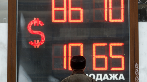 A man looks at the exchange rate at the exchange office in the center of St. Petersburg. February 28, 2022.