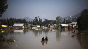 Two figures in a boat in flooded Pakistan