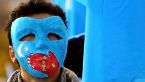 A man takes part in a demonstration against China during its Universal Periodic Review by the UN Rights Council 