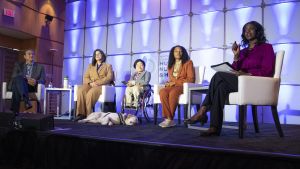 Four speakers and a moderator discuss food insecurity on stage at the 2022 White House Conference on Hunger, Nutrition, and Health.