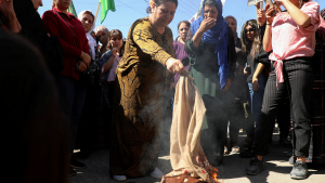 Iranian women burn headscarves in protest.