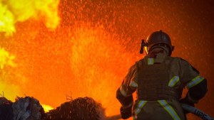 Firefighters battling large orange flames in Ukraine. 