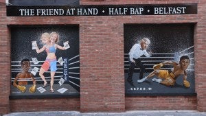 Paintings on a brick wall