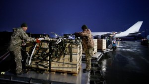 Ukrainian service members unload a shipment of US military aid