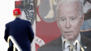 A video of U.S. President Joe Biden is seen on a screen as former U.S. President Donald Trump speaks during a rally ahead of the midterm elections