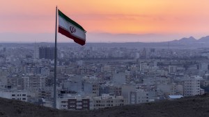 Iran flag with the sunsetting in the background