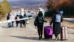 People with suitcases approach the Ukraine-Slovakia border