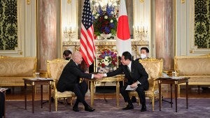US President Joe Biden and Japan's Prime Minister Fumio Kishida shake hands